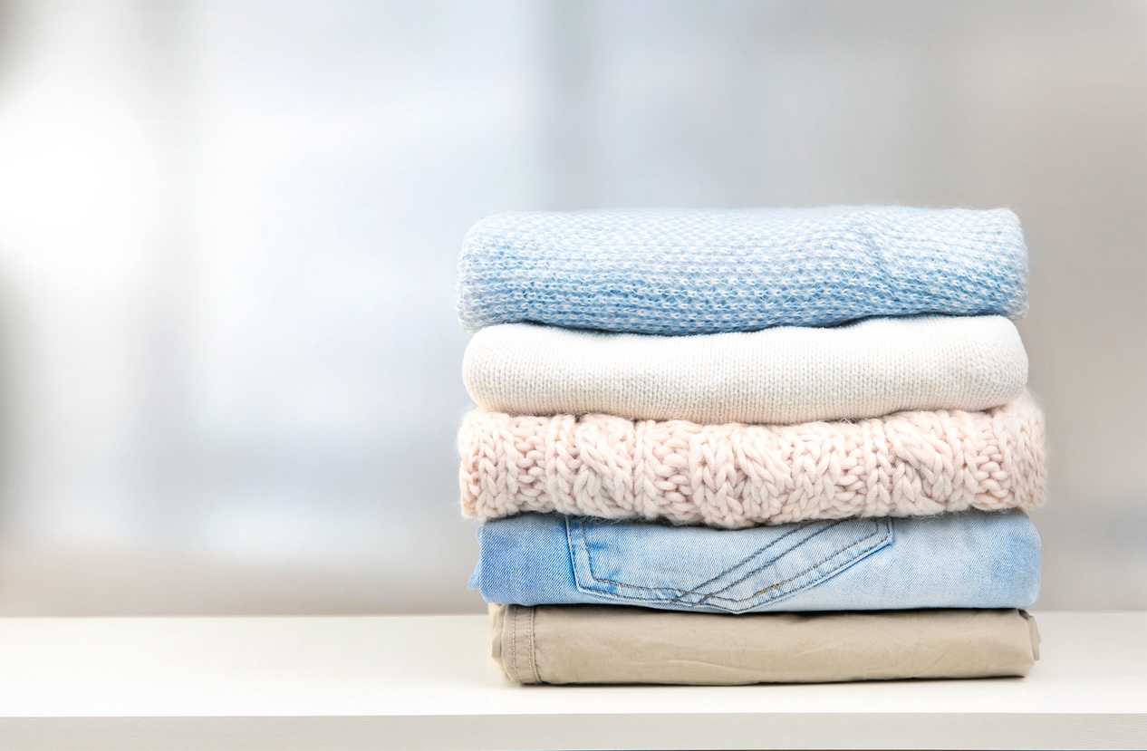 Woman smelling clean laundry, blanket or fabric for fresh and clean smell after washing them